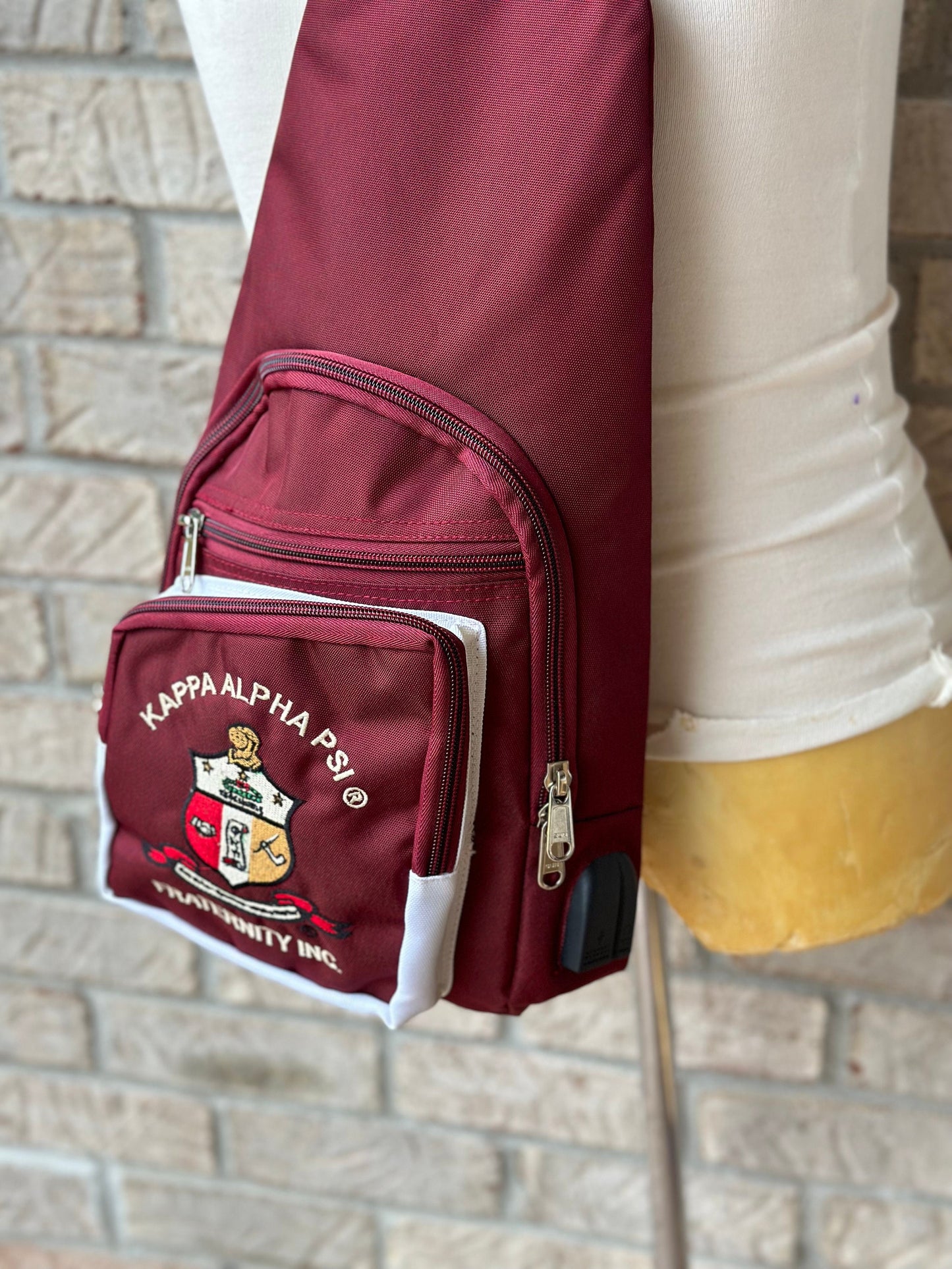 Kappa Alpha Psi Crimson Sling Bag: Embroidered Fraternity Crossbody with USB Port