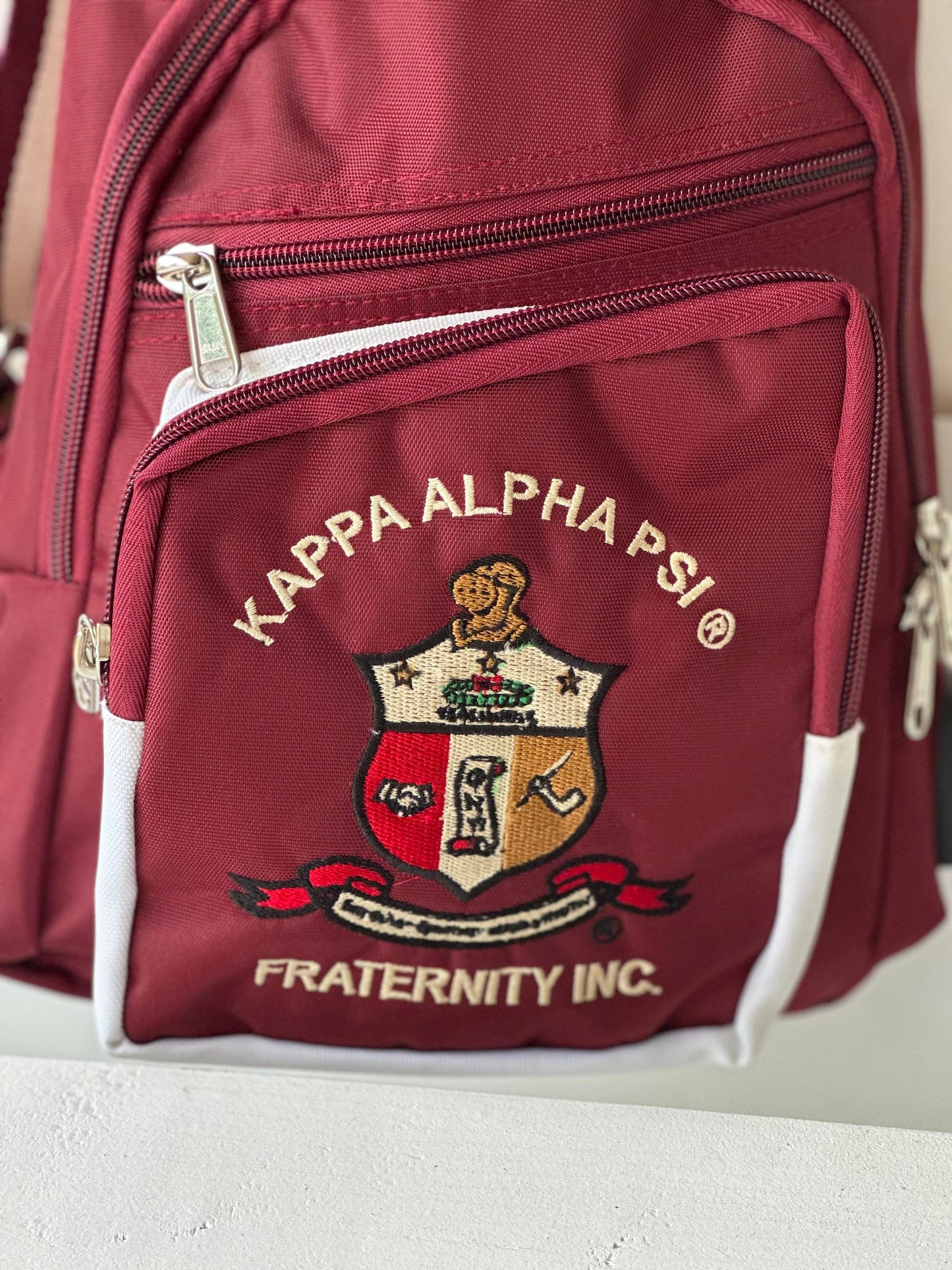 Kappa Alpha Psi Crimson Sling Bag: Embroidered Fraternity Crossbody with USB Port