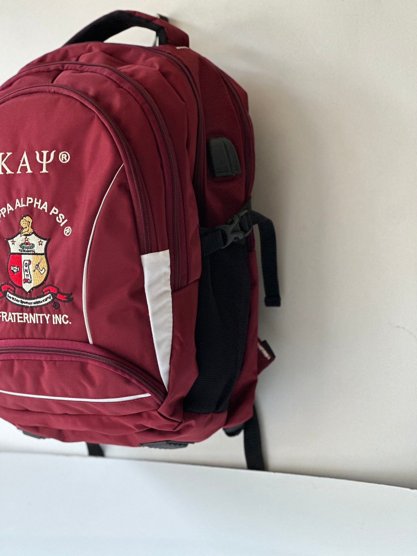 Kappa Alpha Psi (KAΨ) Fraternity Crimson & Black Stylish, Polyester Fabric Coated College Backpack with laptop sleeves For Men.