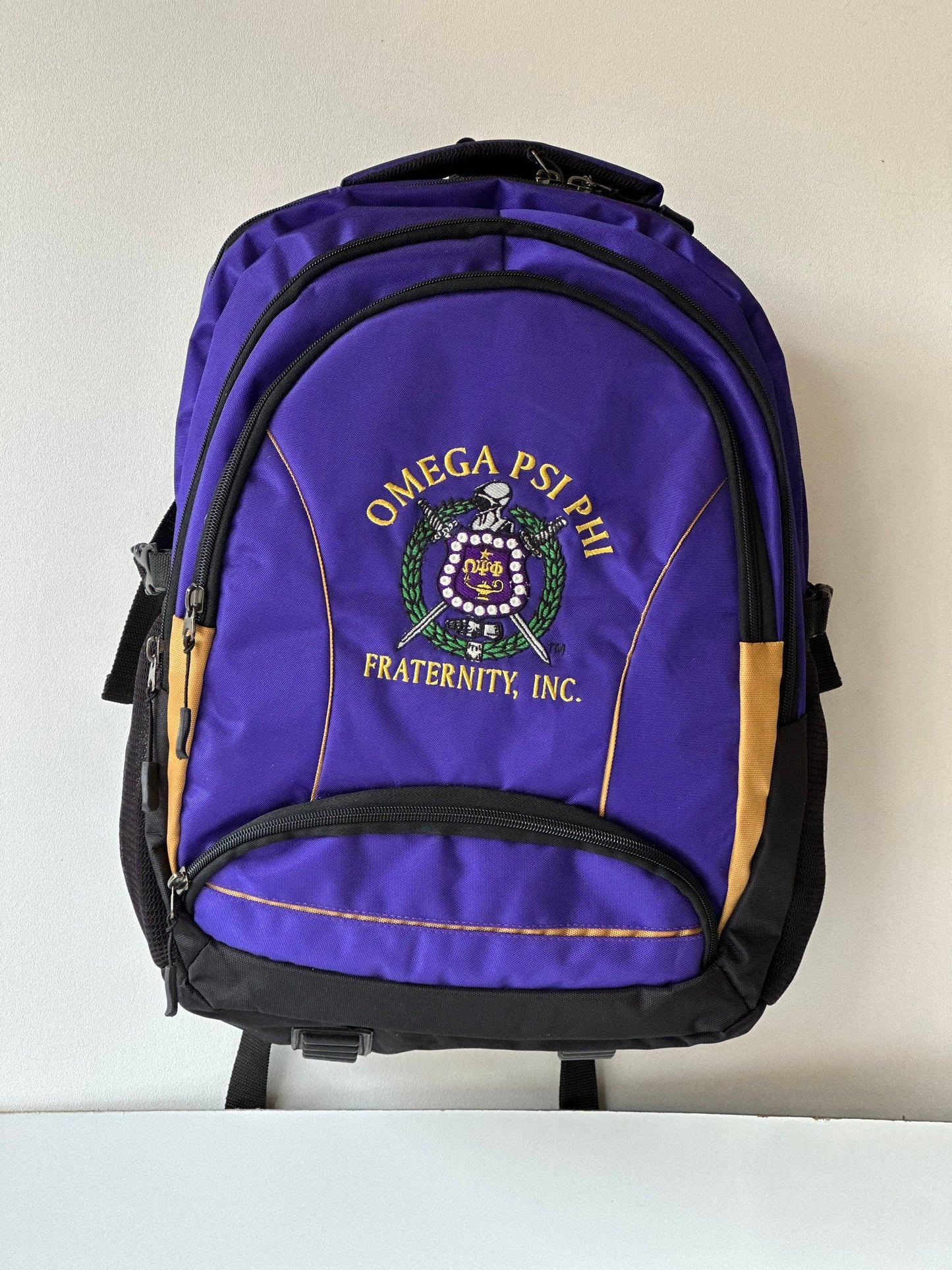 Omega Psi Phi (ΩΨΦ) Fraternity, Purple & gold Stylish, Polyester Fabric Coated College Backpack with laptop sleeves For Men, Made in India.