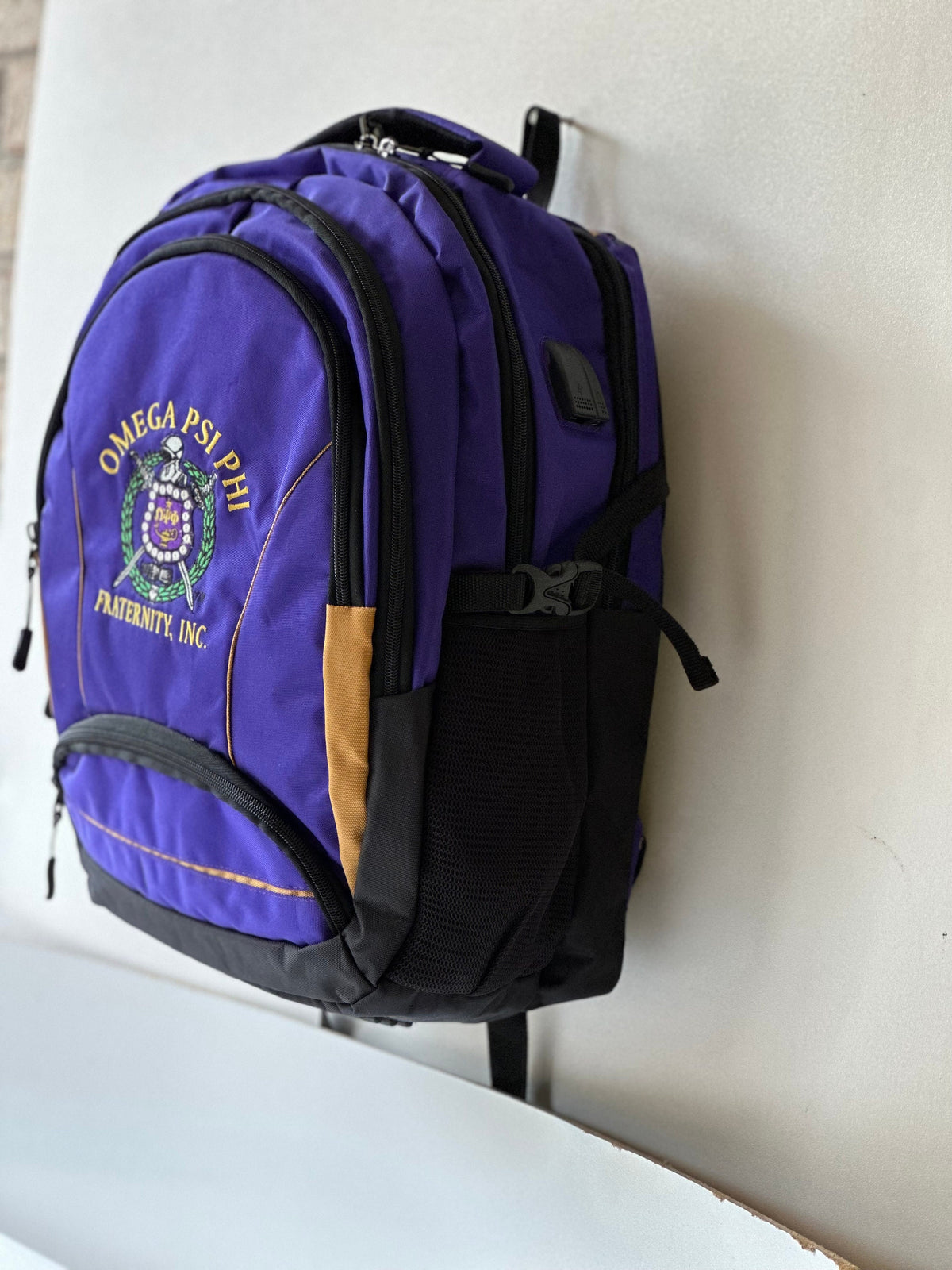 Omega Psi Phi (ΩΨΦ) Fraternity, Purple & gold Stylish, Polyester Fabric Coated College Backpack with laptop sleeves For Men, Made in India.