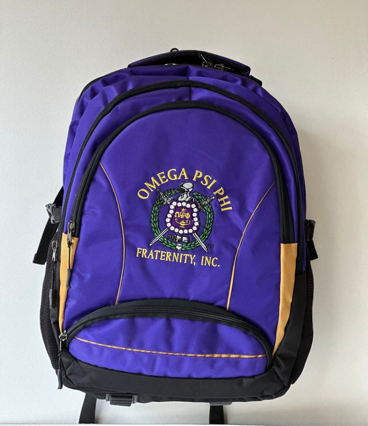 Omega Psi Phi (ΩΨΦ) Fraternity, Purple & gold Stylish, Polyester Fabric Coated College Backpack with laptop sleeves For Men, Made in India.