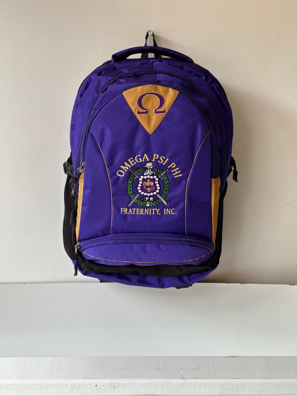 Omega Psi Phi (ΩΨΦ) Fraternity, Purple & gold Stylish, Polyester Fabric Coated College Backpack with laptop sleeves For Men, Made in India.